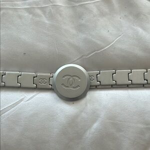 Authentic Chanel Silver adjustable belt with logo on front. Matte silver